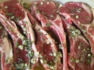 Marinating lamb rib chops with garlic, rosemary and olive oil